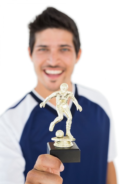 Football player holding winners trophy