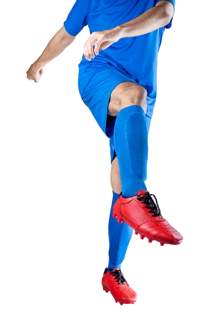 Football player man in a blue jersey with the pose of kicking the ball