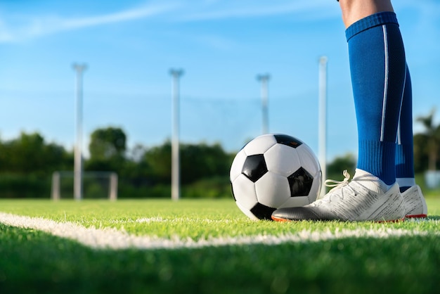 フットボール選手は、国際リーグのサッカーの試合で得点を得るために、シュートまたはキックの前にフリーキック ポイントで芝生の上にボール サッカーを設定します。