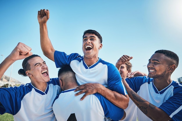 Football player winner team and people winning in competition game or sports goals success and cheers Yes wow and excited group of young men with achievement and soccer celebration on blue sky