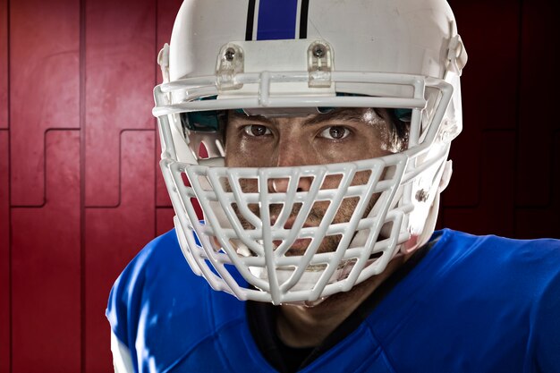 Football Player with a blue uniform on a Locker roon