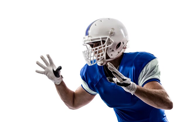 Football Player with a blue uniform making a tackle on a white wall