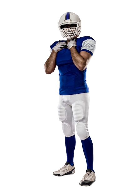 Football Player with a blue uniform on a White wall