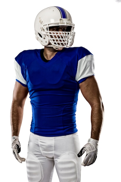 Football Player with a blue uniform on a white wall