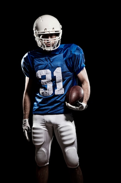 Football Player with number on a blue uniform and a ball in the hand.