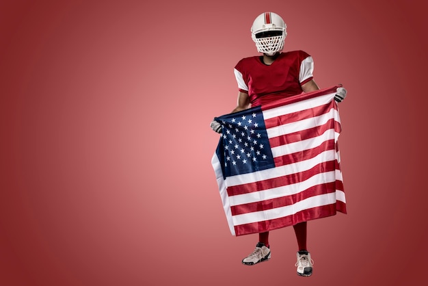 Football Player with a red uniform and a american flag, on a red wall