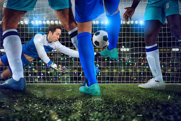 Football scene with soccer players and goalkeeper at the stadium