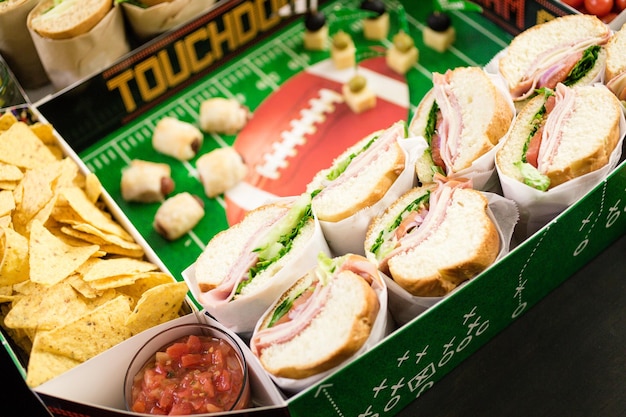 Football Snack Stadium filled with sub sandwiches, veggies and chips.