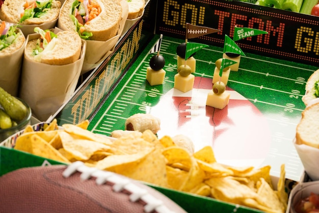 Photo football snack stadium filled with sub sandwiches, veggies and chips.