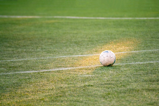 Football soccer ball on the field of grasss