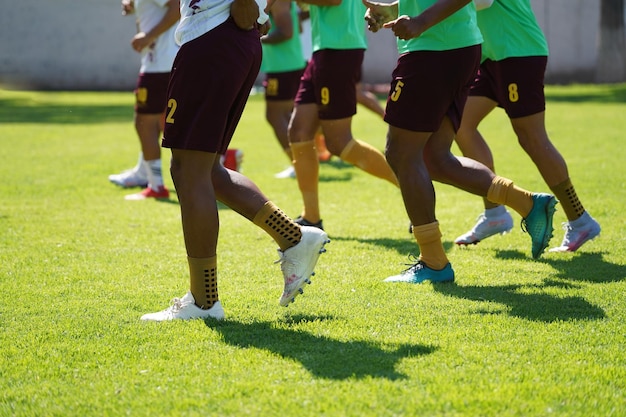 Football soccer players running warming up on the field.