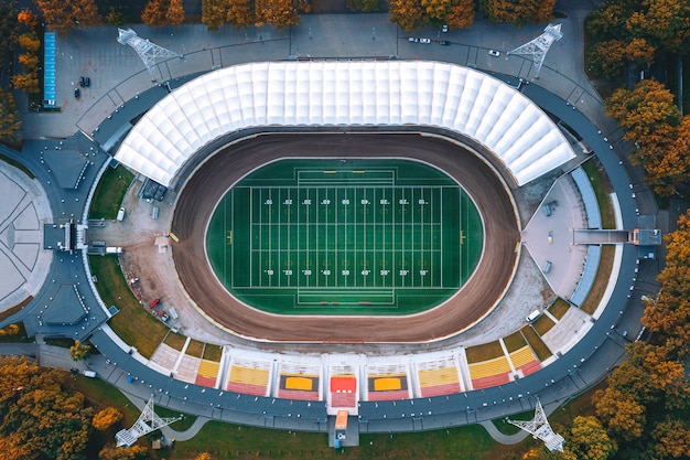 Football stadium with bright green grass and white line markings. American football. View from above