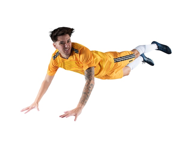 Football striker player with yellow team suit jumps