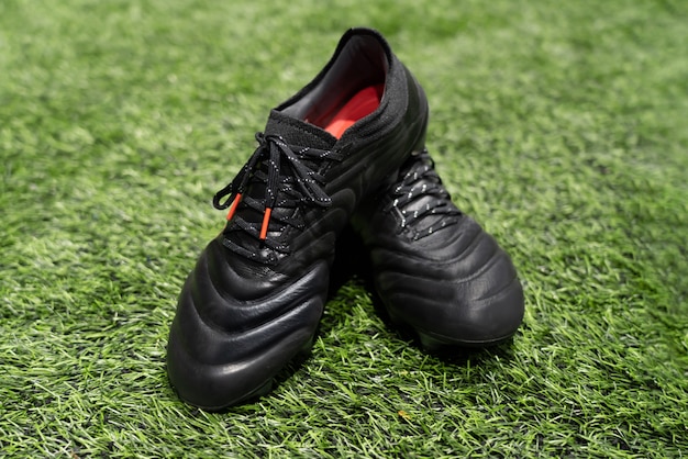 Football stud shoes on artificial grass field