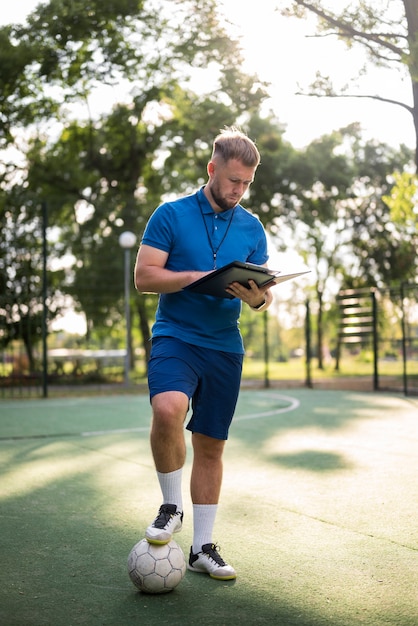 Football trainer teaching his pupils