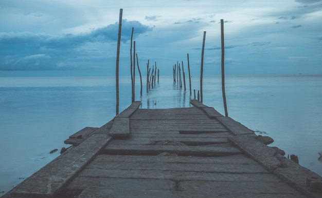 Footbridge sea beach for journey calm hormone Wooden pier or jetty remains on a blue ocean