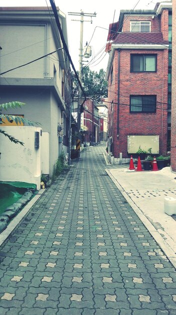 Footpath amidst buildings in city