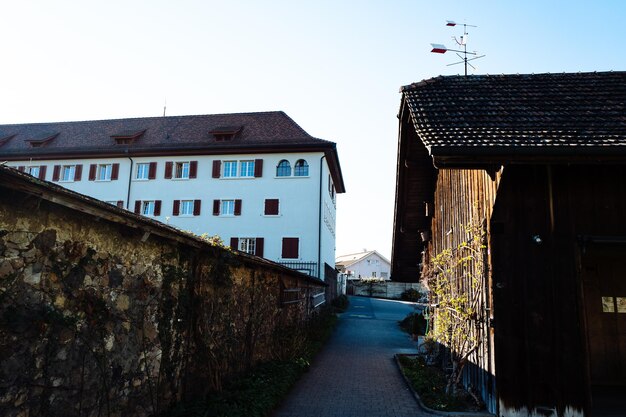 Footpath amidst buildings in town against sky