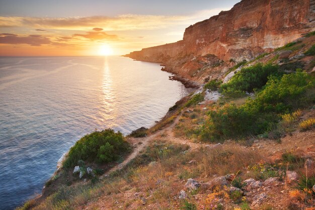 Footpath in mountains and sea sunset