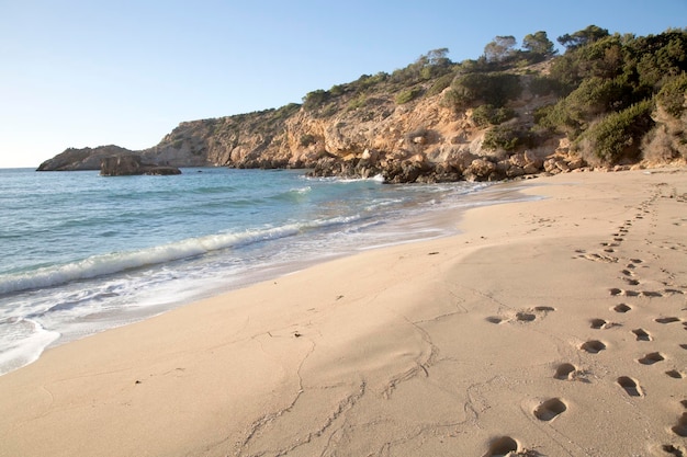 Footprints at Cala Tarida Beach in Ibiza, Spain