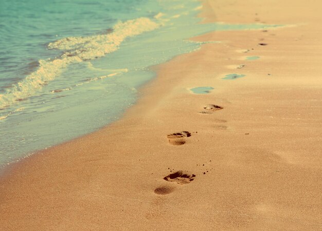 Footprints on sand beach vintage retro style