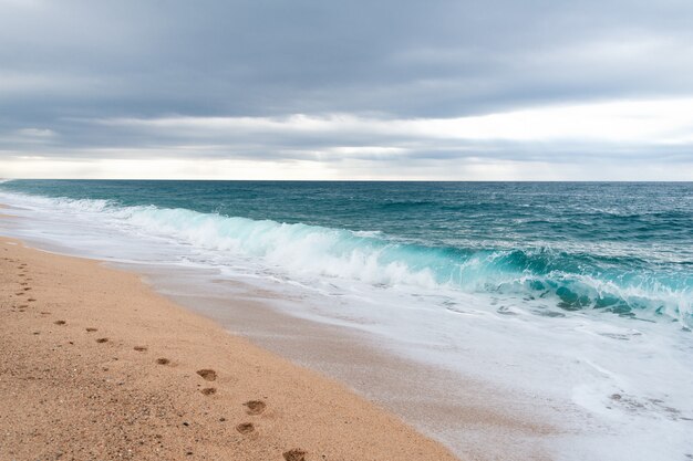 Footprints on the sand at the empty beach