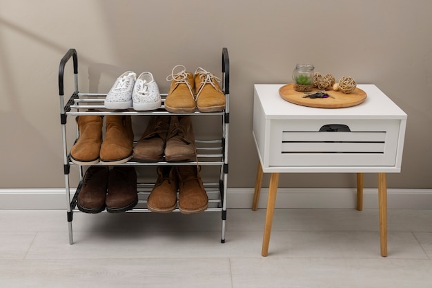 Photo footwear stacked in shoe rack indoors