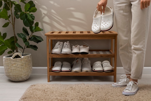 Photo footwear stacked in shoe rack indoors