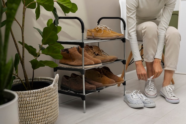 Footwear stacked in shoe rack indoors