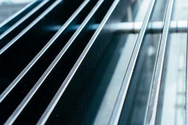 Photo forced glass handrail in parallel lines in office building close up view