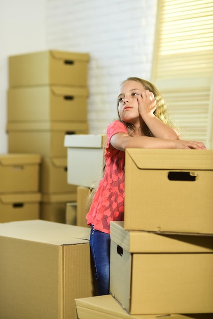 Forced to move Girl child and boxes Move out concept Prepare for moving Rent house Kid moving out Moving routine Packaging things Stressful situation Divorce and separation Family problem