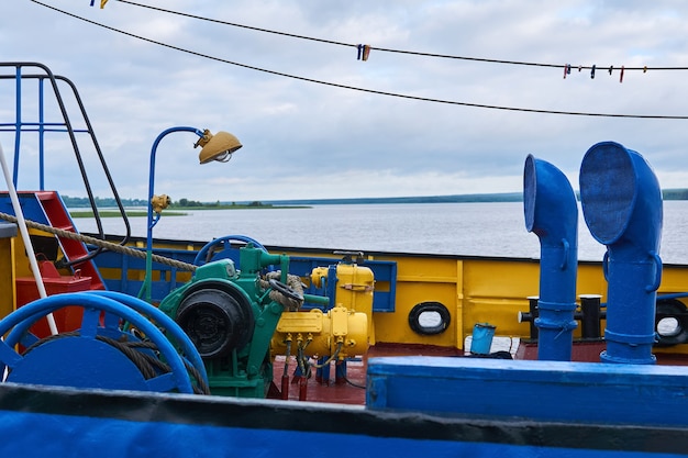 Forecastle of a small river tugboat with the necessary mechanisms, painted in bright colors