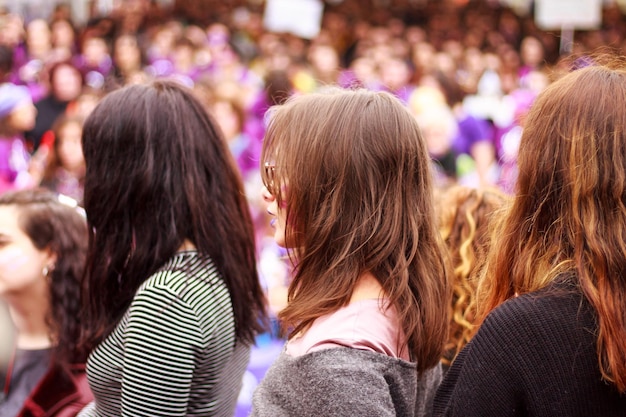 In the foreground three young women forming part of the concentration of international women's day