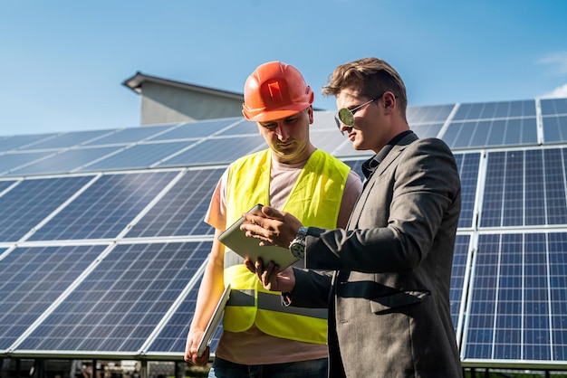 Foreman and engineer work during checking and repairing solar photovoltaic panel