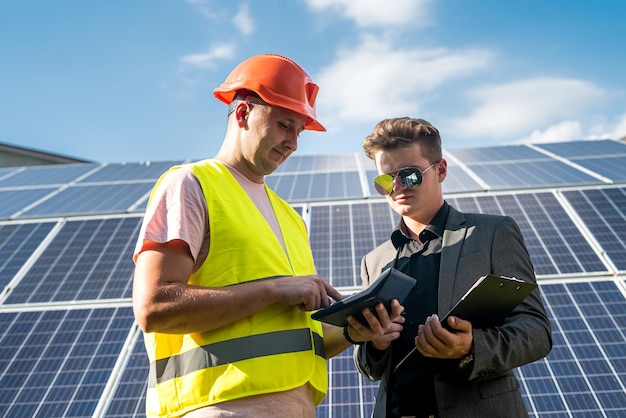 Foreman and engineer work during checking and repairing solar photovoltaic panel