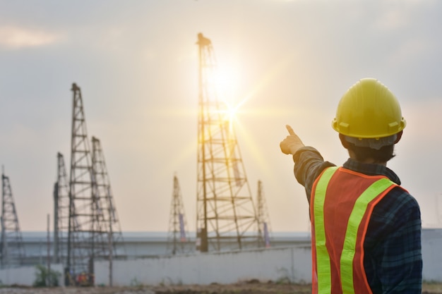 Foreman standing at building construction estate on morning