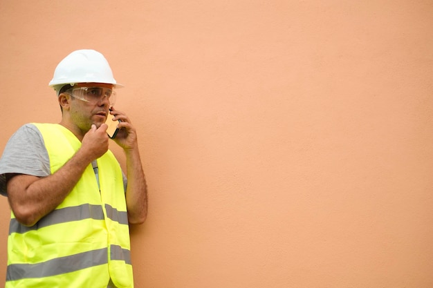 Foreman talks on the phone while gesturing with his hands.