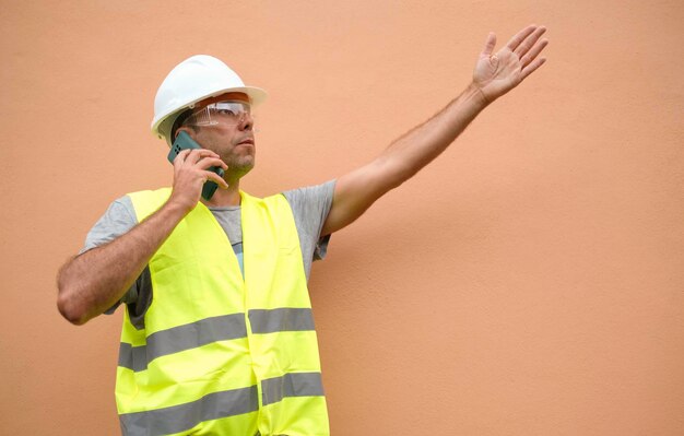 Foreman talks on the phone while gesturing with his hands.