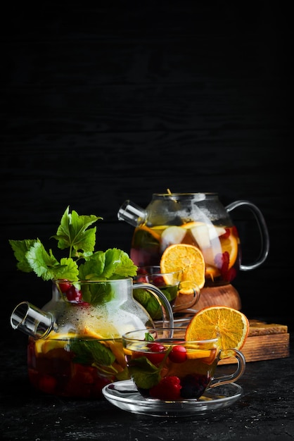 Forest berry and fruit tea Hot winter drinks On a black background Top view