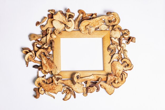 Forest dried edible mushrooms pile with frame