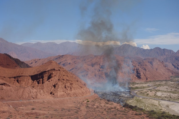 Forest fire in the dry valley on the way Cafayate x Salta north of Argentina desert landscape