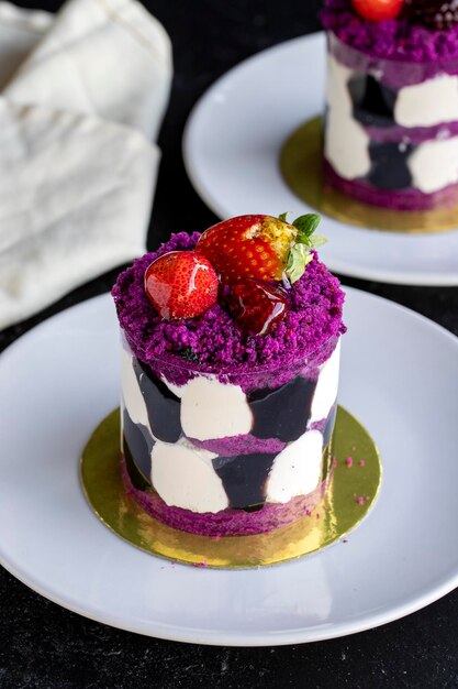 Forest fruit mini cake on a dark background Closeup Vertical view