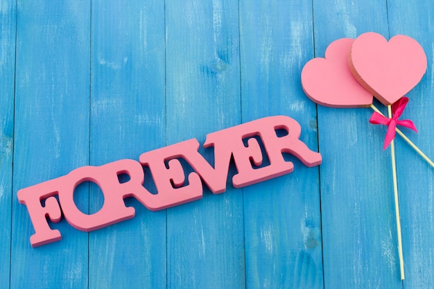 Forever text with hearts on wooden