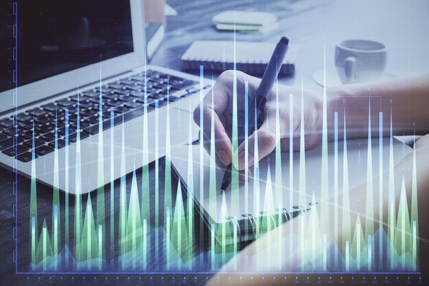 Forex chart displayed on woman's hand taking notes background Concept of research Double exposure