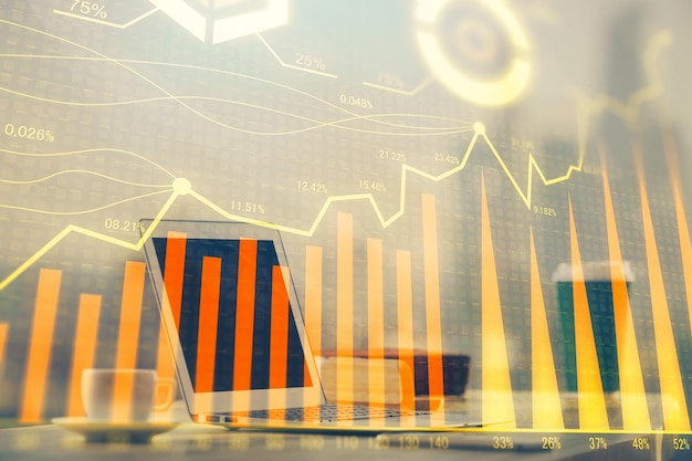 Forex Chart hologram on table with computer background Double exposure Concept of financial markets