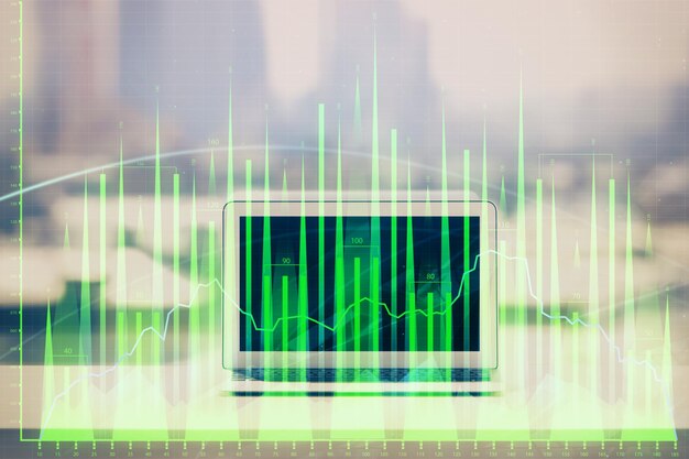 Foto forex grafiek hologram op tafel met computer achtergrond multi-exposure concept van financiële markten