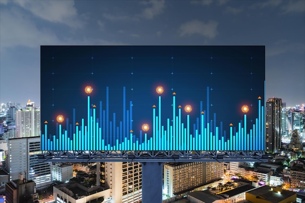 Forex graph hologram on billboard aerial night panoramic\
cityscape of bangkok the developed location for stock market\
researchers in southeast asia the concept of fundamental\
analysis