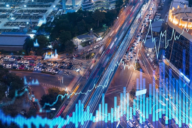 FOREX graph hologram over night busy road traffic in Bangkok the developed location for stock market researchers in Southeast Asia The concept of fundamental analysis Double exposure