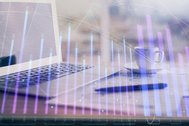 Forex graph hologram on table with computer background Double exposure Concept of financial markets