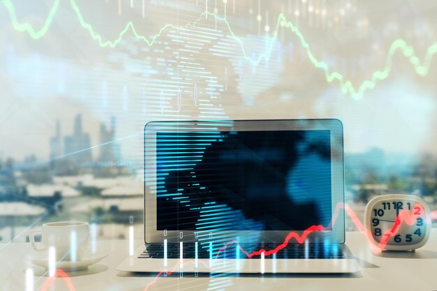 forex graph hologram on table with computer background multi exposure concept of financial markets